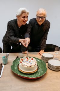 Harry and Jiska cutting a cake with 30 years Meron written on it