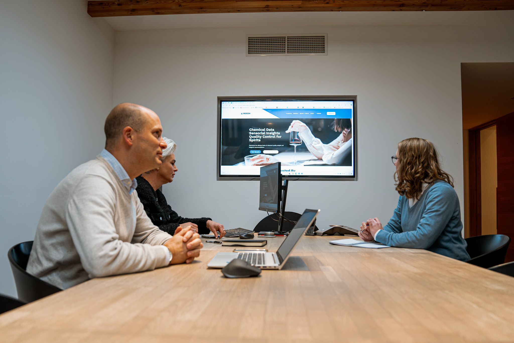 Three people in a meeting to gain market share in wines